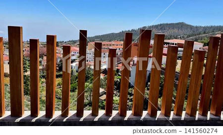 A Beautiful Scenic View Through a Stylish Wooden Fence Surrounded by Modern Architecture A Beautiful Scenic View Through a Stylish Wooden Fence Surrounded by Modern Architecture 141560274