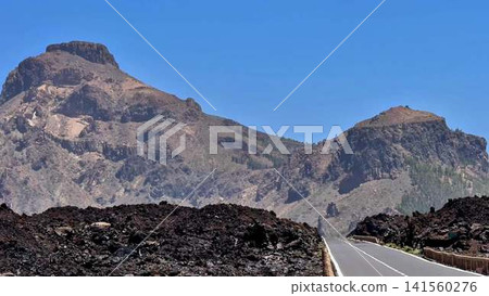 Explore the breathtaking scenic mountain road that winds through a stunning volcanic landscape Explore the breathtaking scenic mountain road that winds through a stunning volcanic landscape 141560276