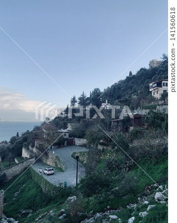 Alanya fortress on hillside with coastal view and residential buildings in the background Alanya fortress on hillside with coastal view and residential buildings in the background 141560618