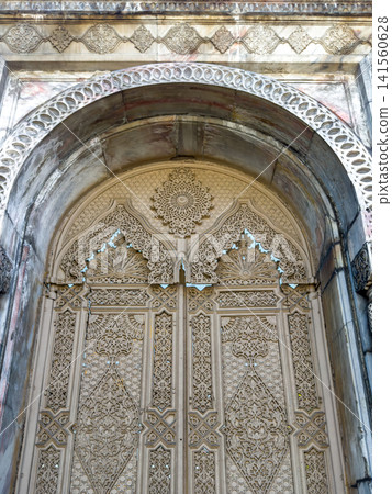 Ornate stone archway with intricate carvings and decorative patterns 141560628