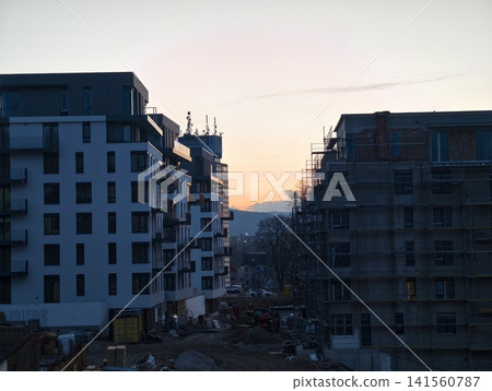 Modern city apartment. Urban residence with scenic views. Contemporary building with terraces during sunset Modern city apartment. Urban residence with scenic views. Contemporary building with terraces during sunset 141560787