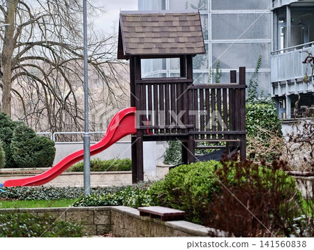 Deserted wooden play area overlooking city. Abandoned play structure in quiet neighborhood setting Deserted wooden play area overlooking city. Abandoned play structure in quiet neighborhood setting 141560838