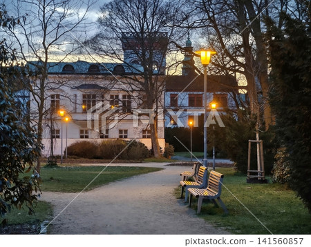 Serene urban park captures peaceful ambiance with soft lamp illumination and gentle evening breeze Serene urban park captures peaceful ambiance with soft lamp illumination and gentle evening breeze 141560857