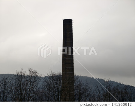 Rural landscape depiction. Tranquil scene where nature overtakes former industrial structures today Rural landscape depiction. Tranquil scene where nature overtakes former industrial structures today 141560912