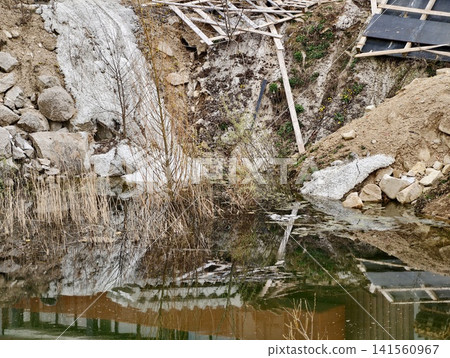 Environmental observer records abandoned landscape. Old quarry transformed by natural growth and decay Environmental observer records abandoned landscape. Old quarry transformed by natural growth and decay 141560967