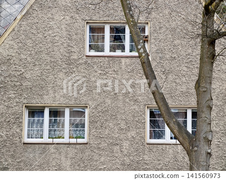 Ancient concrete structure with surroundings. Weathered facade of building with scenic elements 141560973