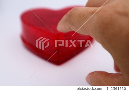 A person reaching out to the heart A person reaching out to the heart 141561330