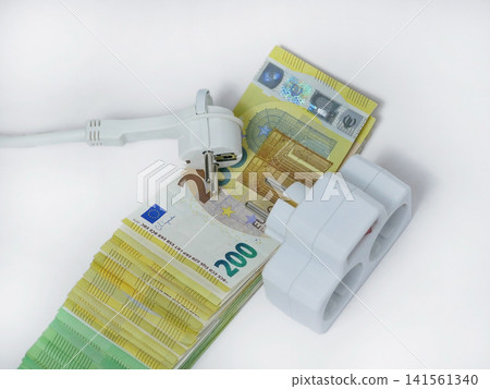 Electrical extension socket and power plug placed on euro banknotes, illustrating rising electricity prices, increasing energy costs, utility bills, inflation and household expenses in Europe Electrical extension socket and power plug placed on euro banknotes, illustrating rising electricity prices, increasing energy costs, utility bills, inflation and household expenses in Europe 141561340