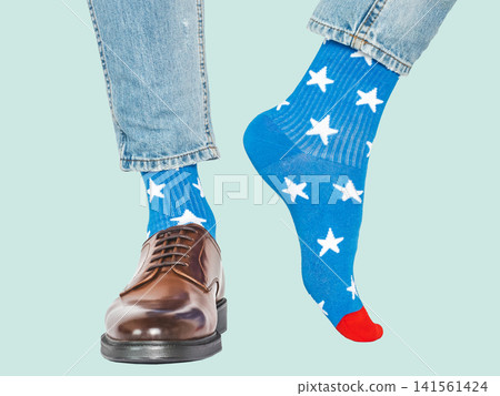 Men's legs and blue socks with white stars Men's legs and blue socks with white stars 141561424