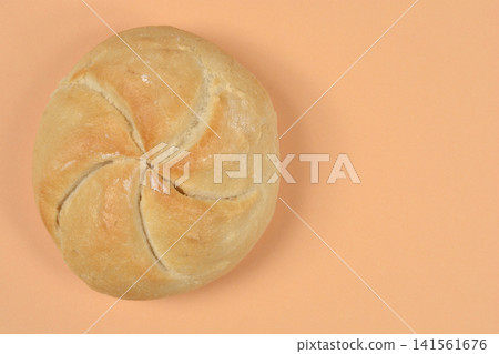 Single Kaiser Roll on Peach Background with Copy Space Single Kaiser Roll on Peach Background with Copy Space 141561676
