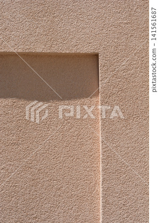 Beige plaster wall texture with a geometric recessed architectural detail Beige plaster wall texture with a geometric recessed architectural detail 141561687