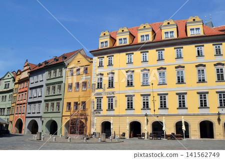Colorful row of historic european townhouses on empty square in Prague for cityscape background and travel poster design. Old Town Square of Prague Colorful row of historic european townhouses on empty square in Prague for cityscape background and travel poster design. Old Town Square of Prague 141562749