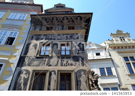 Historic sgraffito facade with mural decorations and carved stone details in Prague for travel background and architecture poster Historic sgraffito facade with mural decorations and carved stone details in Prague for travel background and architecture poster 141563953