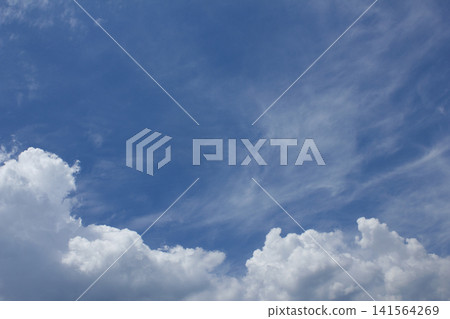 It is a blue sky with fluffy clouds. It is a blue sky with fluffy clouds. 141564269