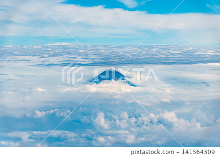 Aerial view of Mount Fuji peeking through the clouds. Aerial view of Mount Fuji peeking through the clouds. 141564309