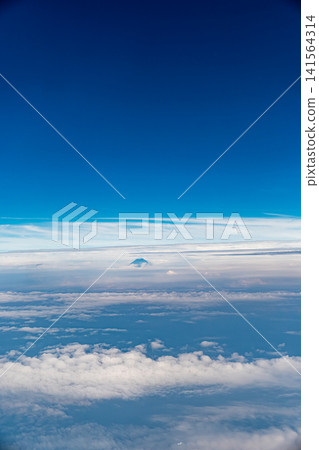 Aerial view of Mount Fuji peeking through the clouds. Aerial view of Mount Fuji peeking through the clouds. 141564314
