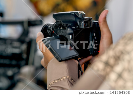 photographer taking photo with camera photographer taking photo with camera 141564508