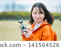 Young woman operating a drone Young woman operating a drone 141564526
