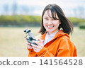 Young woman operating a drone Young woman operating a drone 141564528