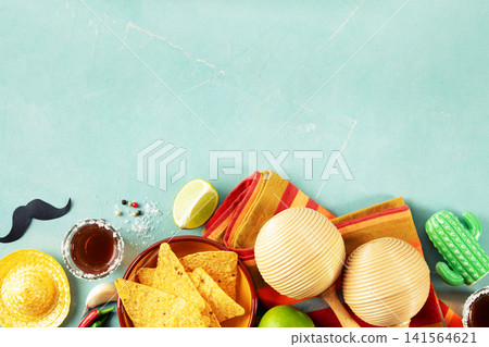 Cinco de Mayo Festive Setup with Nachos, Tequila, and Maracas Cinco de Mayo Festive Setup with Nachos, Tequila, and Maracas 141564621