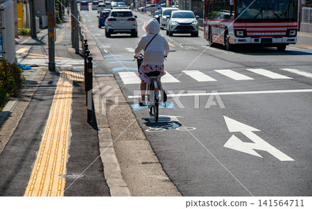 Bicycles riding in bicycle lanes and urban traffic scenes Bicycles riding in bicycle lanes and urban traffic scenes 141564711