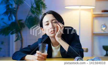 A woman drinking alcohol and becoming sentimental. Alcohol, izakaya (Japanese pub), sad, lonely, solitude, depressed, disappointed, drinking alone A woman drinking alcohol and becoming sentimental. Alcohol, izakaya (Japanese pub), sad, lonely, solitude, depressed, disappointed, drinking alone 141564810