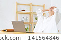A middle-aged woman looks disappointed at her laptop. Feeling down, a failure, disappointed, frustrated, rejected, shocked, streaming, crying. 141564846