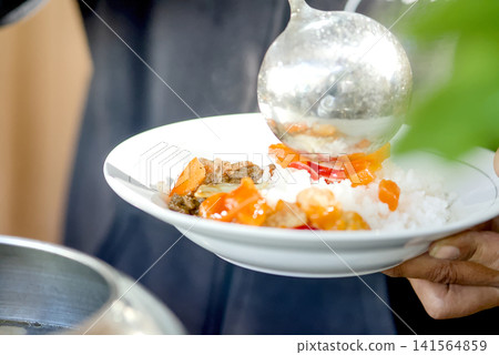 Close-up view of a festive dining moment showing a hand reaching for delicious food served on the table Close-up view of a festive dining moment showing a hand reaching for delicious food served on the table 141564859