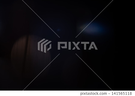 Abstract light leak creating a soft bokeh effect and optical flare on a dark background Abstract light leak creating a soft bokeh effect and optical flare on a dark background 141565118