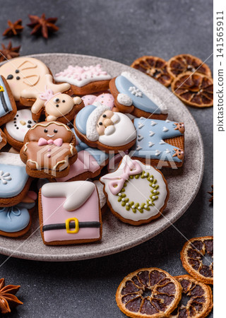 Gingerbread as a Christmas staple, sweet biscuits for the holiday. Gingerbread as a background Gingerbread as a Christmas staple, sweet biscuits for the holiday. Gingerbread as a background 141565911