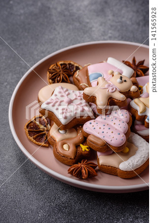 Gingerbread as a Christmas staple, sweet biscuits for the holiday. Gingerbread as a background Gingerbread as a Christmas staple, sweet biscuits for the holiday. Gingerbread as a background 141565928