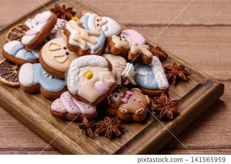 Gingerbread as a Christmas staple, sweet biscuits for the holiday. Gingerbread as a background Gingerbread as a Christmas staple, sweet biscuits for the holiday. Gingerbread as a background 141565959