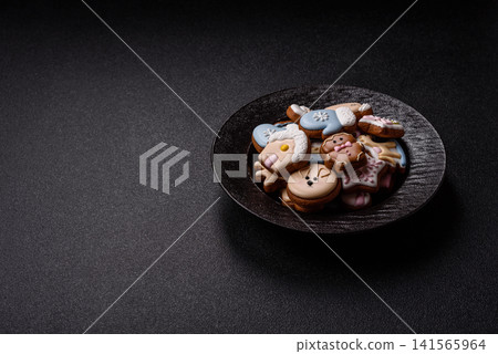 Gingerbread as a Christmas staple, sweet biscuits for the holiday. Gingerbread as a background Gingerbread as a Christmas staple, sweet biscuits for the holiday. Gingerbread as a background 141565964
