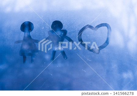 Family figures and heart symbol on wet glass create abstract background with blue tones. Family figures and heart symbol on wet glass create abstract background with blue tones. 141566278