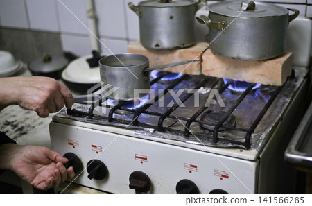 Cold kitchen with brick on stove heating metal pots, Cold kitchen with brick on stove heating metal pots, 141566285