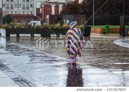 People under rain with umbrellas and raincoats. Heavy rain soaks streets. Weather forecast failed. Rainy day survival with waterproof gear and patience People under rain with umbrellas and raincoats. Heavy rain soaks streets. Weather forecast failed. Rainy day survival with waterproof gear and patience 141567605