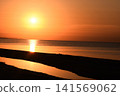 Sun setting over calm sea, 141569062