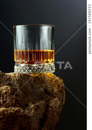 Glass of whiskey on a rough granite. Glass of whiskey on a rough granite. 141569253