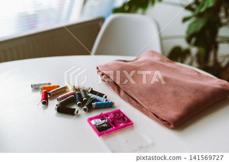 repairing an old pullover 141569727