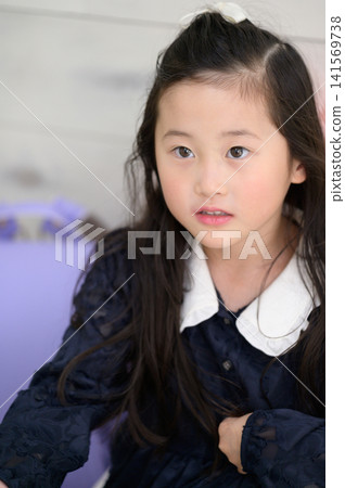 A Japanese girl practicing for her entrance exams. A Japanese girl practicing for her entrance exams. 141569738
