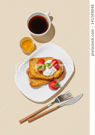 Brioche toasts with strawberries and whipped cream, drizzled with honey on a plate Brioche toasts with strawberries and whipped cream, drizzled with honey on a plate 141569848
