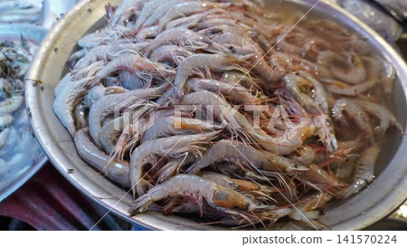 Large silver bowl filled with raw grayish white shrimp Large silver bowl filled with raw grayish white shrimp 141570224