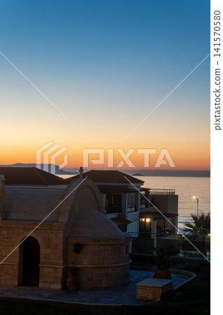 Stone orthodox chapel near seaside resort hotels at twilight sunset Stone orthodox chapel near seaside resort hotels at twilight sunset 141570580