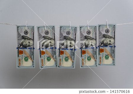 Money Laundering Concept with Dollar Bills on Clothesline Money Laundering Concept with Dollar Bills on Clothesline 141570616