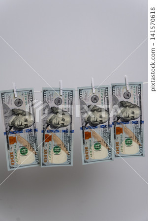 Four US Dollar Bills Hanging on Clothesline Representing Money Laundering Four US Dollar Bills Hanging on Clothesline Representing Money Laundering 141570618