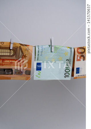 Euro Banknotes Hanging on Rope for Money Laundering Concept Euro Banknotes Hanging on Rope for Money Laundering Concept 141570637