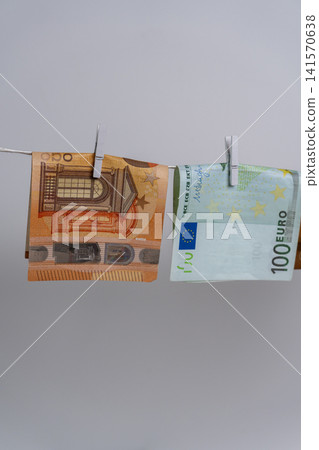 Two Euro Banknotes Hanging on Rope for Money Laundering Concept 141570638