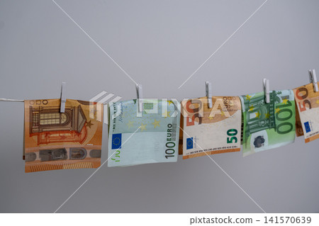 Five Euro Banknotes Hanging on Clothesline for Money Laundering Concept 141570639