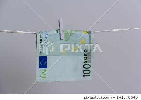 Close Up of One Hundred Euro Banknote on Rope for Money Laundering Concept Close Up of One Hundred Euro Banknote on Rope for Money Laundering Concept 141570640