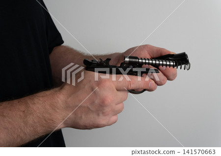 Detailed shot of handgun slide removal during firearm disassembly Detailed shot of handgun slide removal during firearm disassembly 141570663